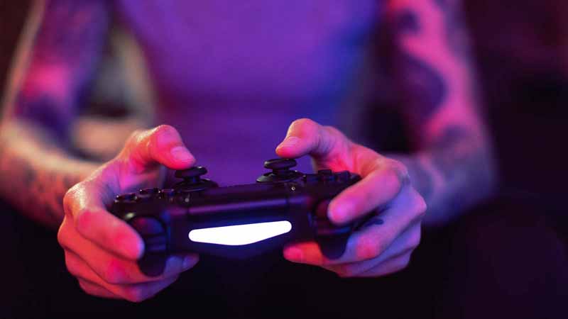 Closeup of a person using a video game controller.