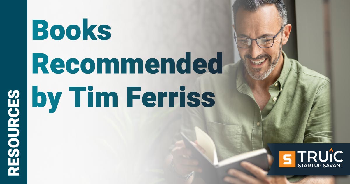 Smiling businessman reading book.