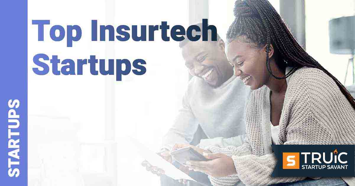 Couple sitting on a couch doing work.