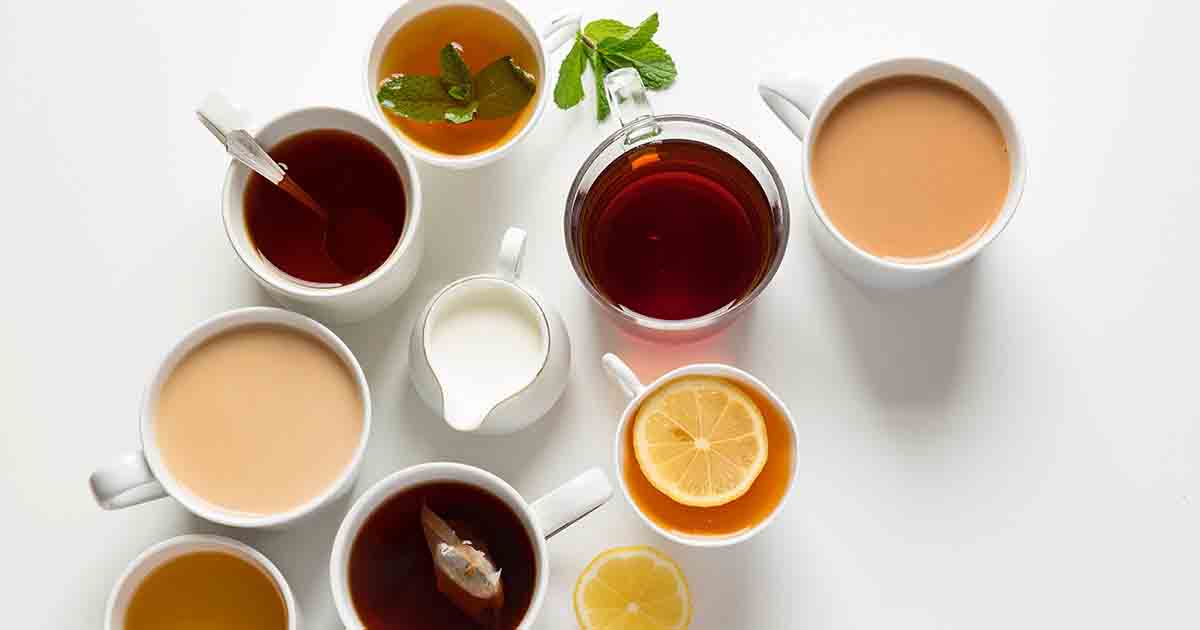 Various tea varieties in white mugs.