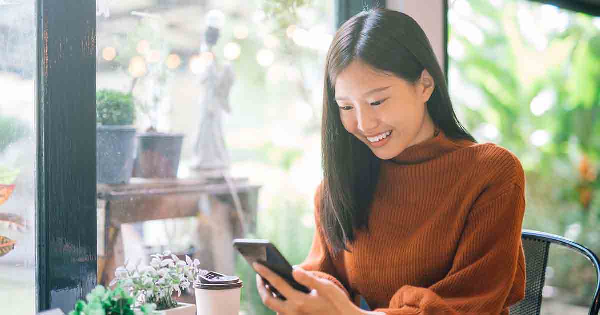 Smiling woman on phone.